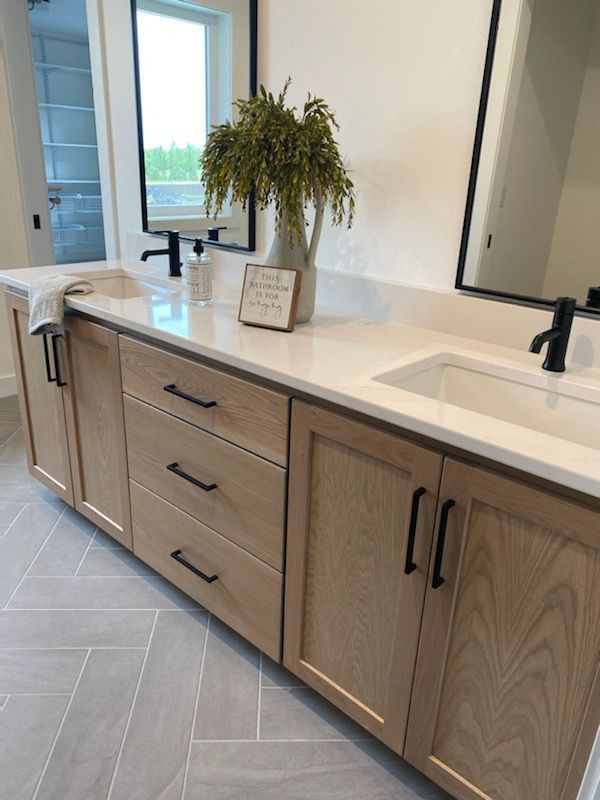 a bathroom with two sinks and a large mirror