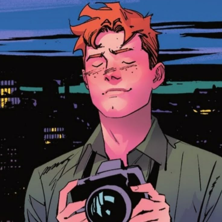 a man with red hair holding a camera in front of his face and looking into the distance