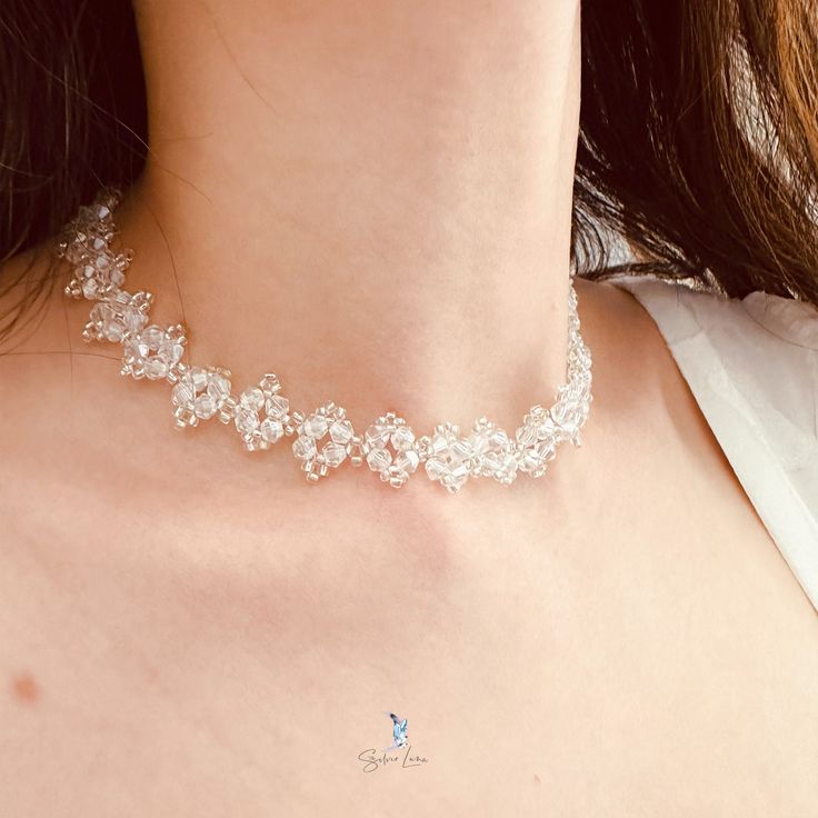 This white crystal bead choker is perfect for cocktail party outfit, wedding party, features shiny white bead with adjustable chain. Add this white rhinestone choker to your everyday fashion jewelry collection or as gift for your love one. Choker length: 13 +2 inches Materials: beads Jewelry Care: See more information about how to care for your jewelry here. Shipping Policy: Orders will be shipped within 1-3 business days. Economy shipping will take 7-14 days to arrive and standard shipping is 1 Adjustable Pearl Chain Beaded Necklaces For Party, Adjustable Beaded Necklaces With Pearl Chain For Party, White Crystal Necklace With Rhinestones For Party, White Crystal Necklaces With Rhinestones For Party, Elegant White Choker With Clavicle Chain, White Pearl Clavicle Choker Necklace, Dainty Sparkling Necklace For Party, Party Rhinestone Necklace With Adjustable Clavicle Chain, Beaded Pearl Choker Necklaces For Party