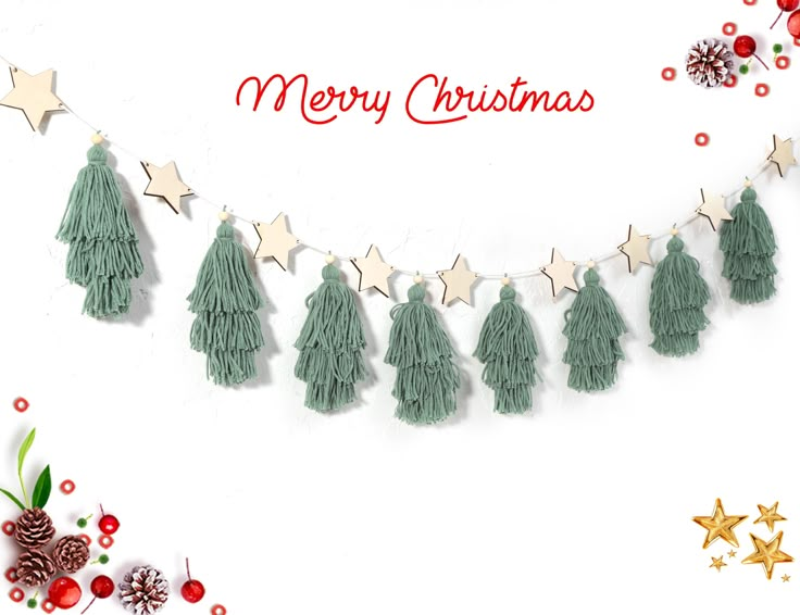 a merry christmas card with tassels and stars on the string, surrounded by other holiday decorations