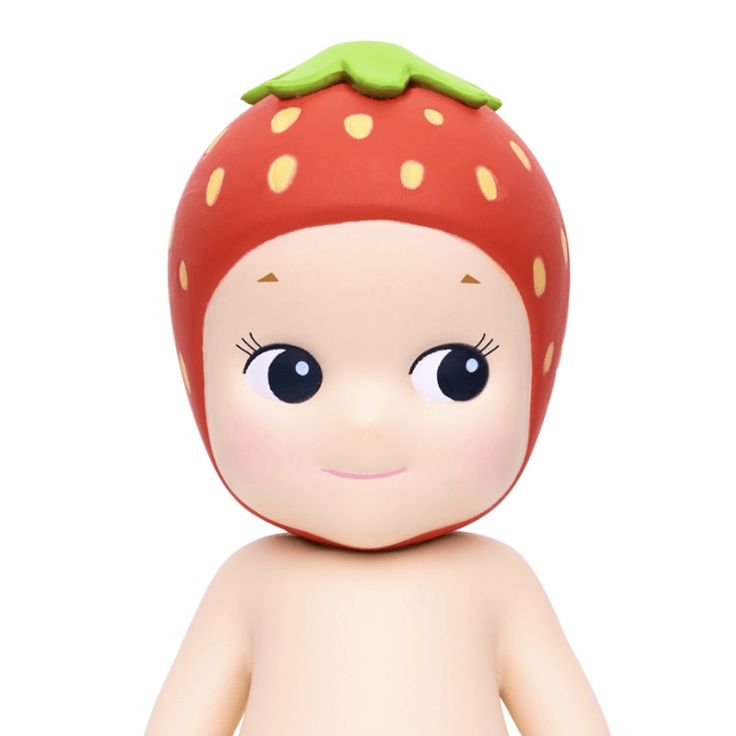 a close up of a toy with a strawberry on it's head