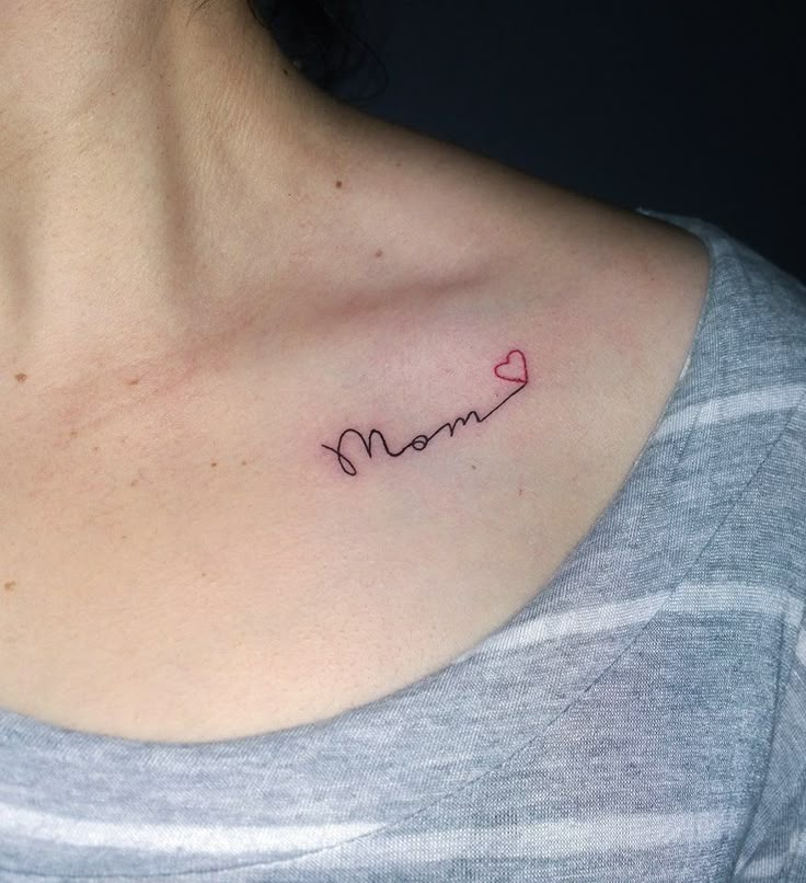 a woman's chest with the word mom written in cursive writing on it