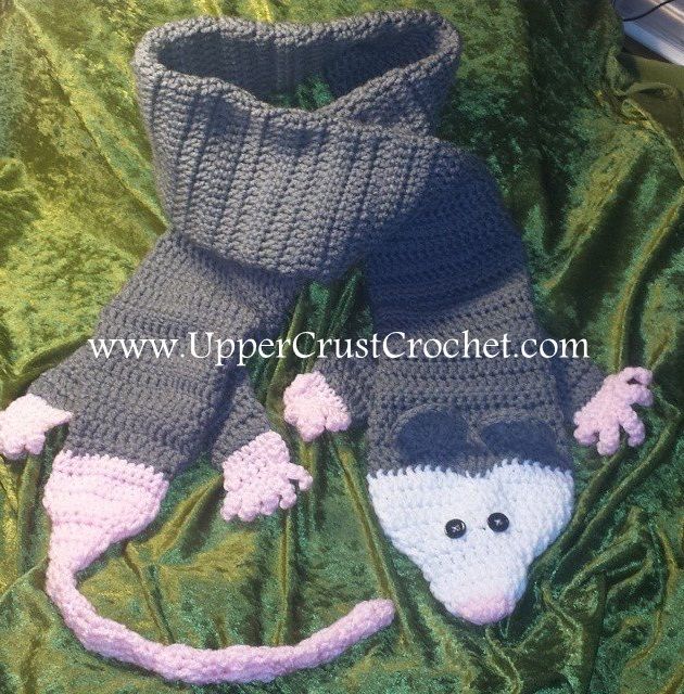 a pair of knitted slippers with a mouse on them