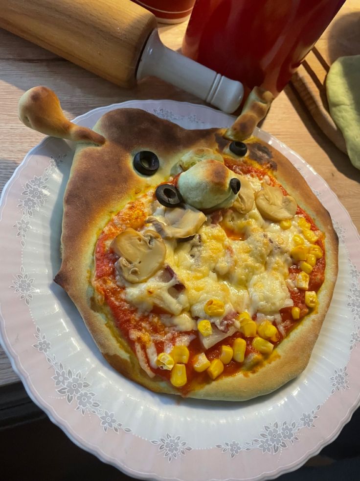 a pizza sitting on top of a white plate