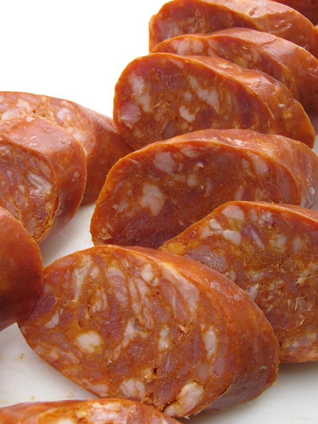 several slices of sausage on a white surface