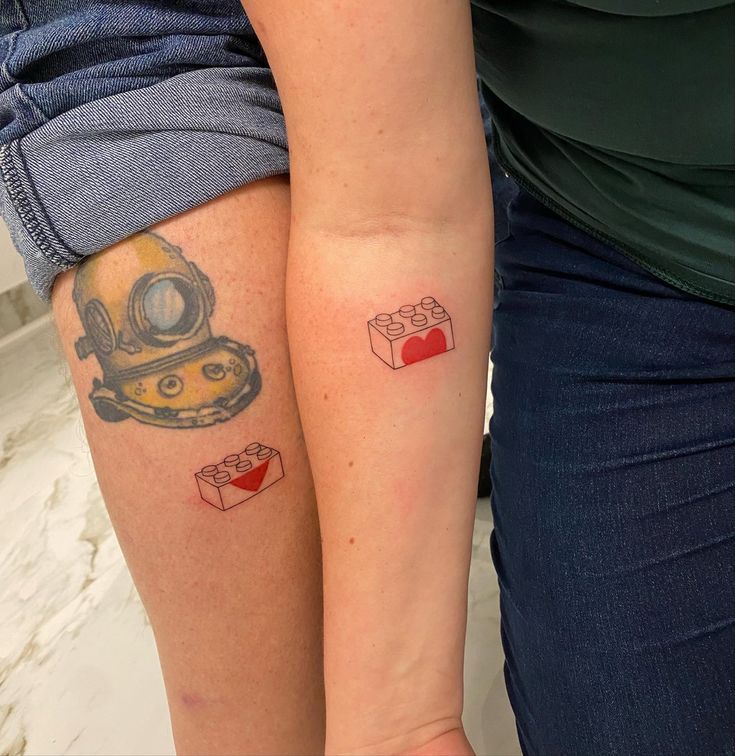 two people with matching tattoos on their arms