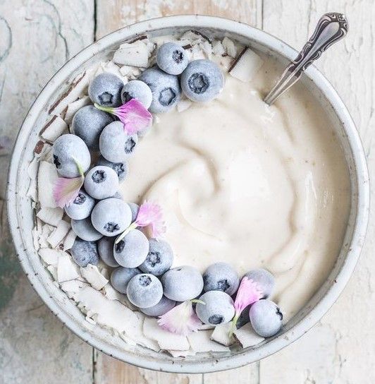 a bowl filled with yogurt and blueberries