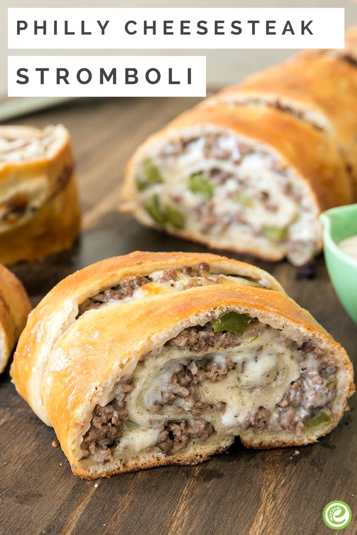 some meat and cheese stuffed rolls on a wooden table with a cup of tea in the background