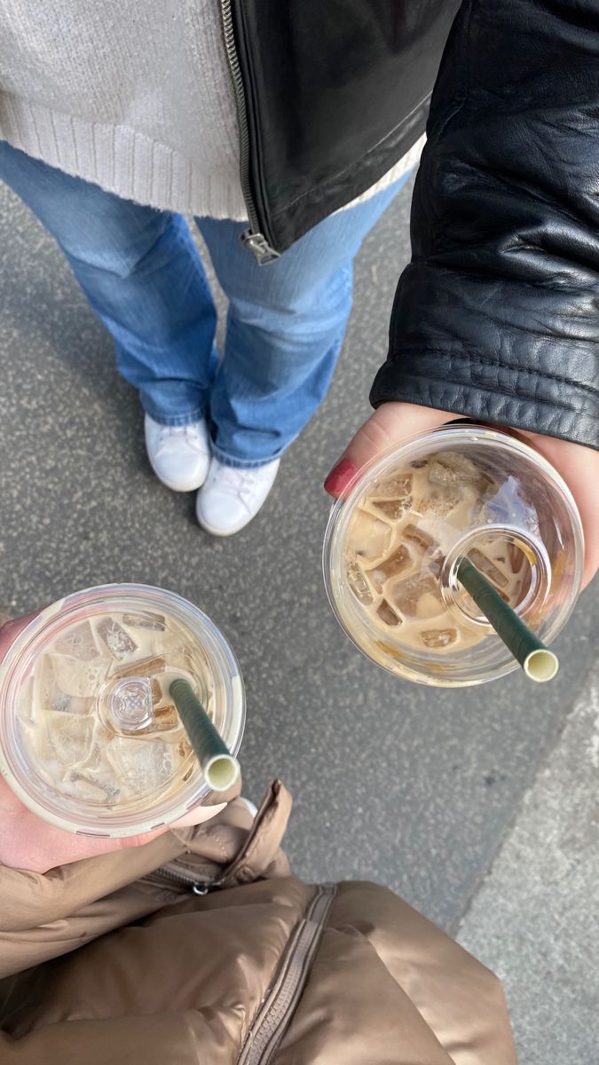 two people holding drinks in their hands