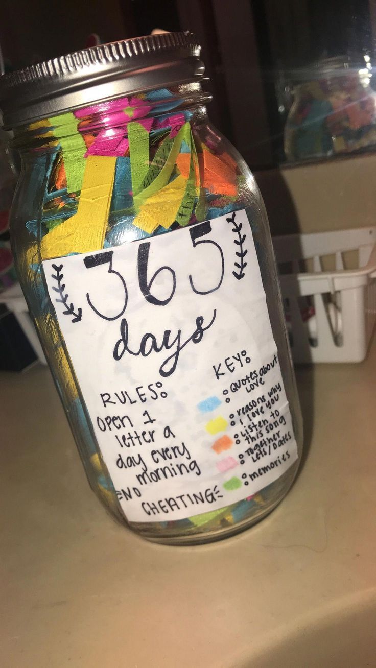 a glass jar filled with lots of different colored ribbons and writing on the label that says 65 days