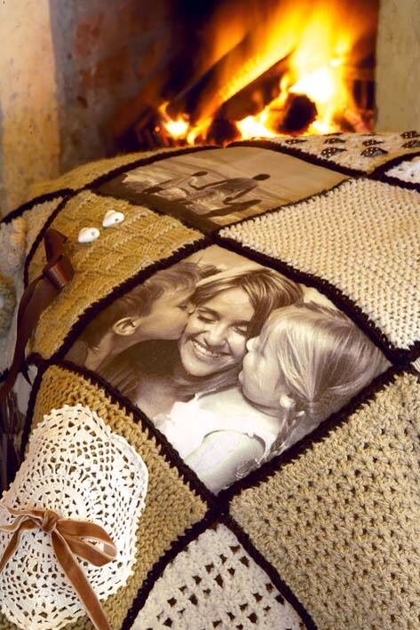 a blanket with pictures on it and a ribbon tied around the edges is shown in front of a fire place