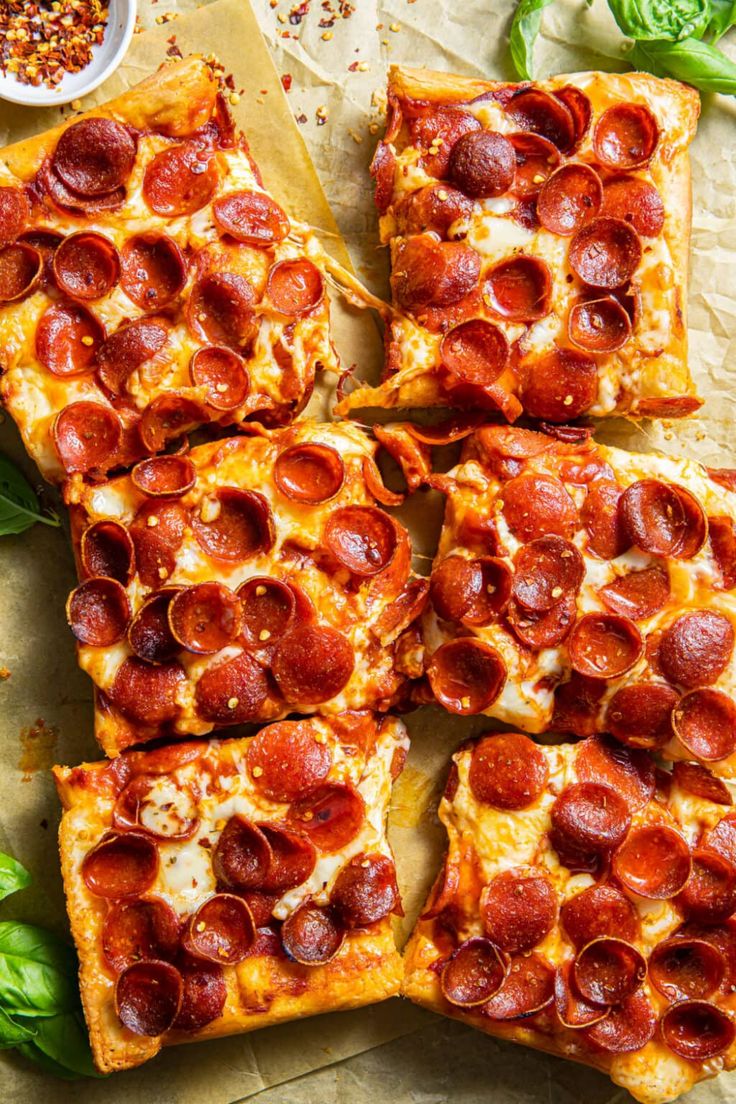 several slices of pepperoni pizza on a cutting board