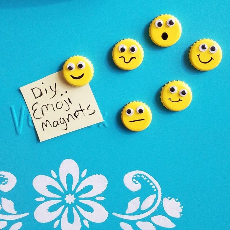 five yellow smiley face magnets sitting on top of a blue table next to a note that says diy emo magnets