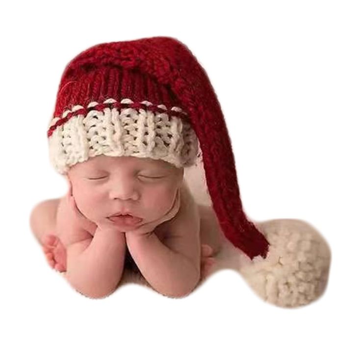 a baby wearing a red and white knitted hat