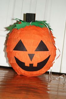 a pumpkin shaped lantern sitting on top of a wooden floor