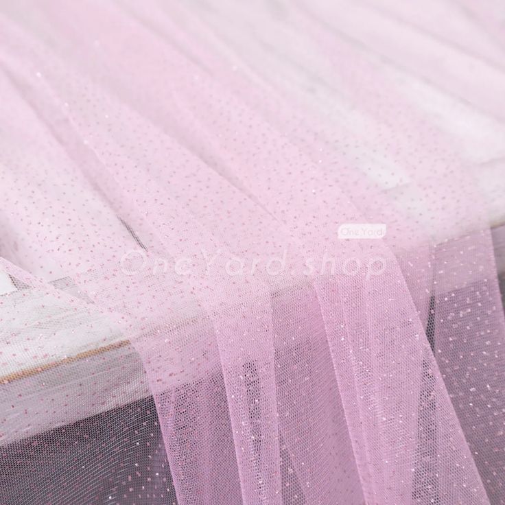 pink tulle with white dots on it