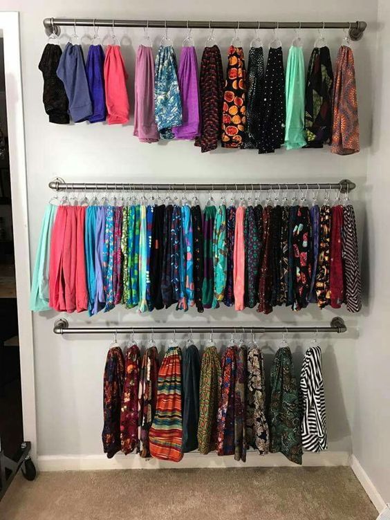 a closet filled with lots of colorful clothes