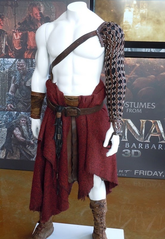 a male mannequin dressed in red and brown clothing