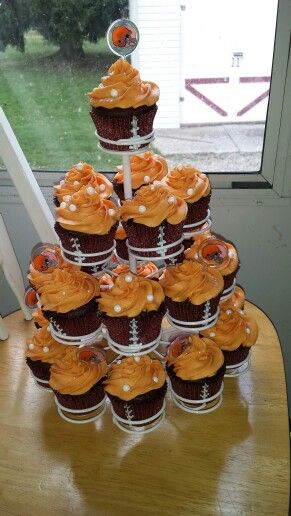 cupcakes are stacked on top of each other in front of an open window