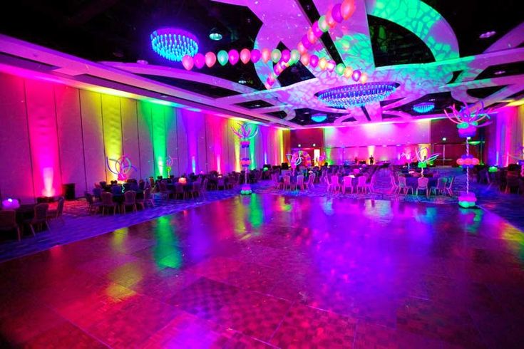 the dance floor is lit up with colorful lights