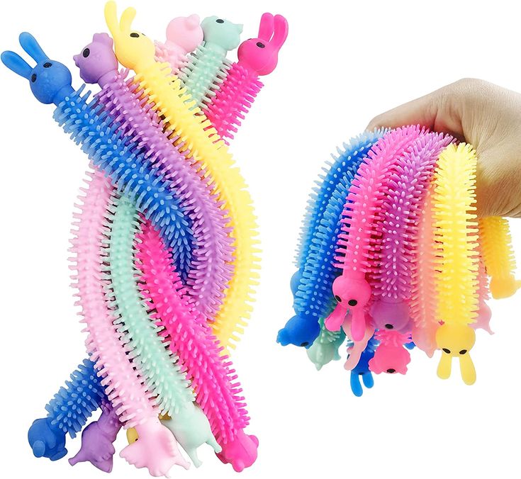 a hand holding several different colored hairbrushes in it's palm and the other one has an animal design on it