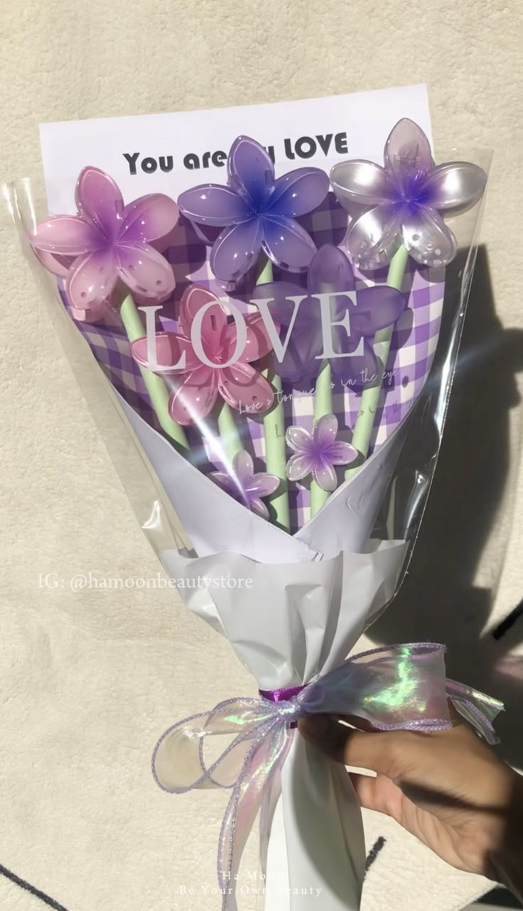 a person holding a bouquet of flowers with the words you are my love written on it