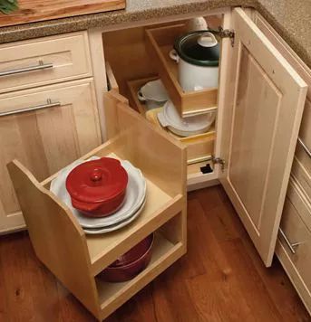 an open cabinet in the middle of a kitchen