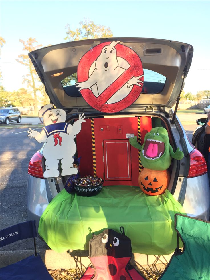 the trunk of a car is filled with halloween decorations