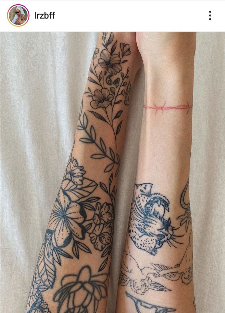 two people with tattoos on their arms and legs, both holding each other's hands