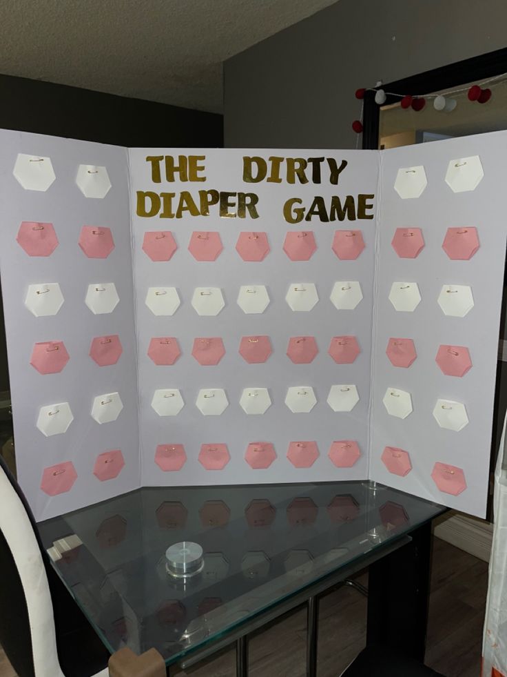 the dirty diaper game is set up on a glass table with chairs around it