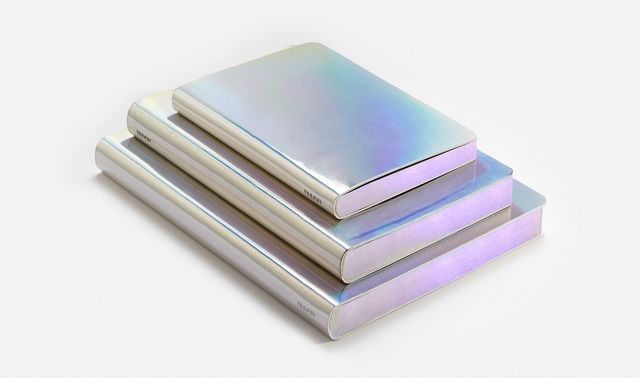 three silver colored coasters stacked on top of each other in front of a white background