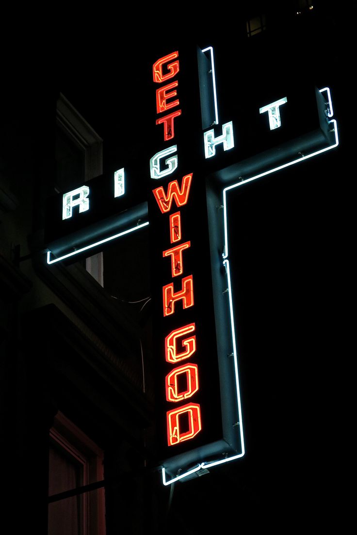 a neon sign that is on the side of a building