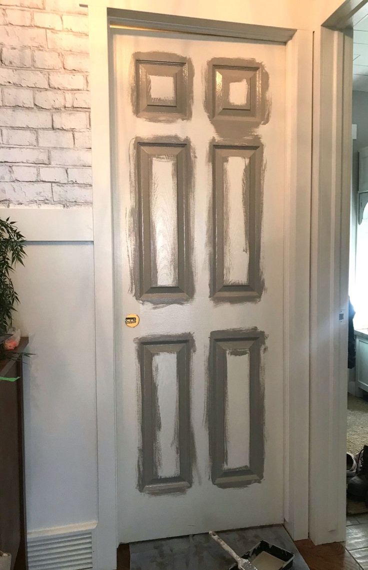 the door is being painted with gray paint