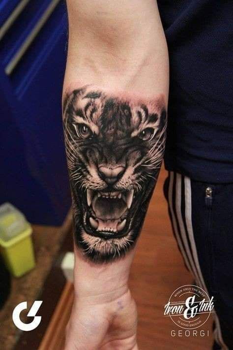 a man with a tiger tattoo on his arm