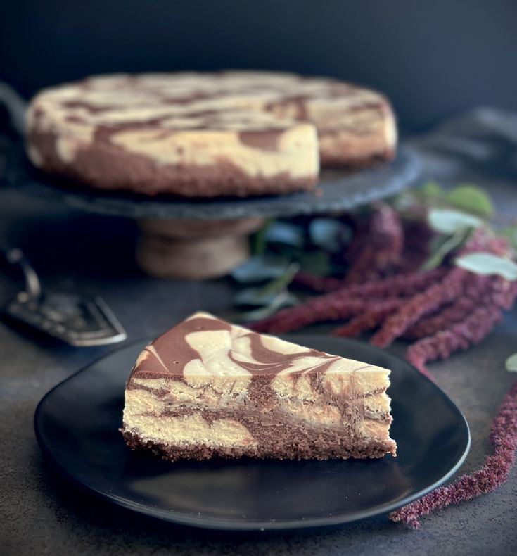 two slices of cheesecake sitting on top of black plates