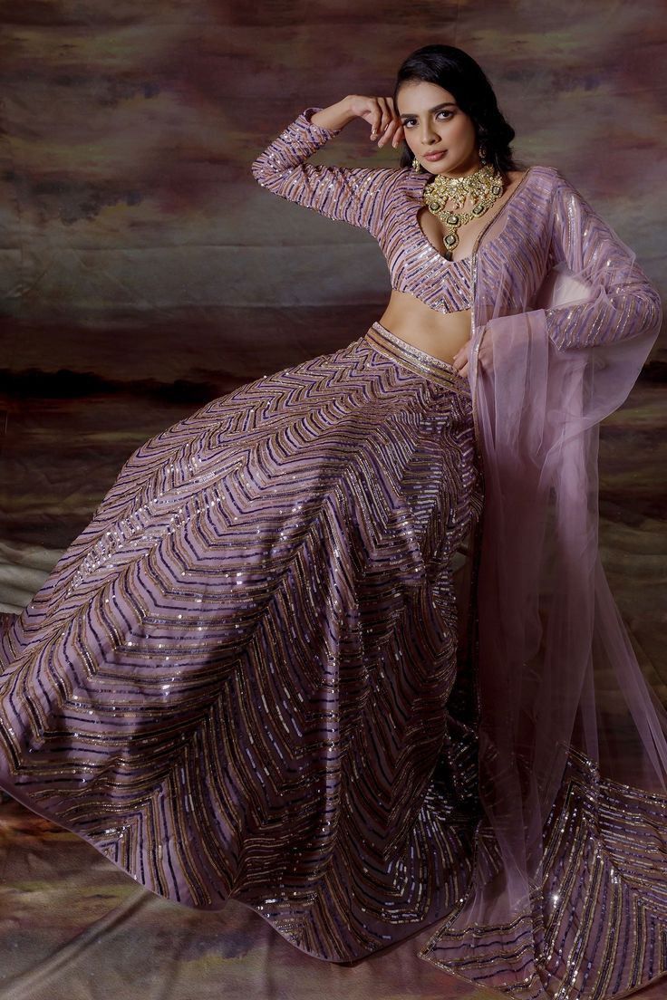 Burnished lilac organza lehenga with geometric sequin stripes. Paired with embroidered blouse and net dupatta.
Component: 3
Pattern: Embroidered
Type Of Work: Geometric
Neckline: Scoop
Sleeve Type: Long Sleeves
Fabric: Organza, Net
Color: Purple
Other Details: 
Embroidered dupatta
Sequin work
Back tassel tie-up
Occasion: Sangeet, Reception - Aza Fashions Scoop Neckline Blouse, Stylish Lehenga, Organza Lehenga, Pale Lilac, Embellished Skirt, Lehenga Skirt, Lehenga Blouse, Skirt And Blouse, Net Dupatta