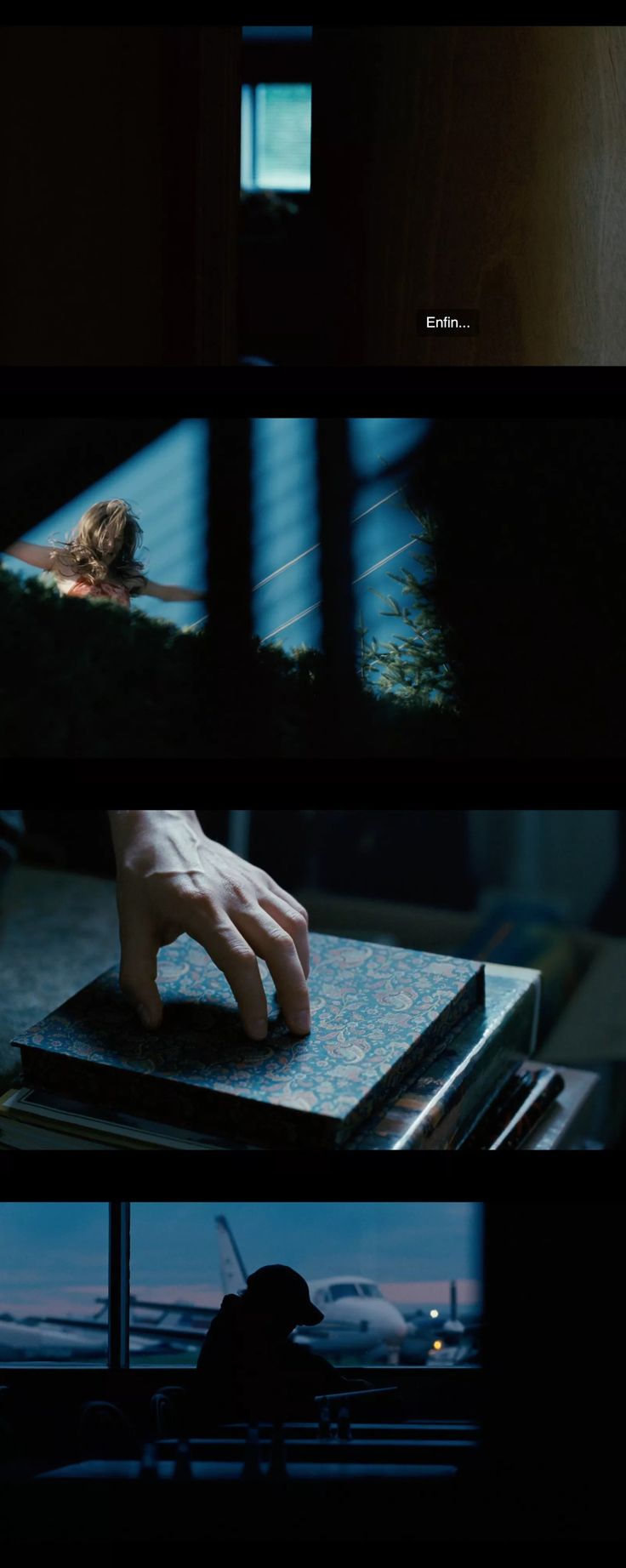 the hand that is on top of a book in front of a window at night