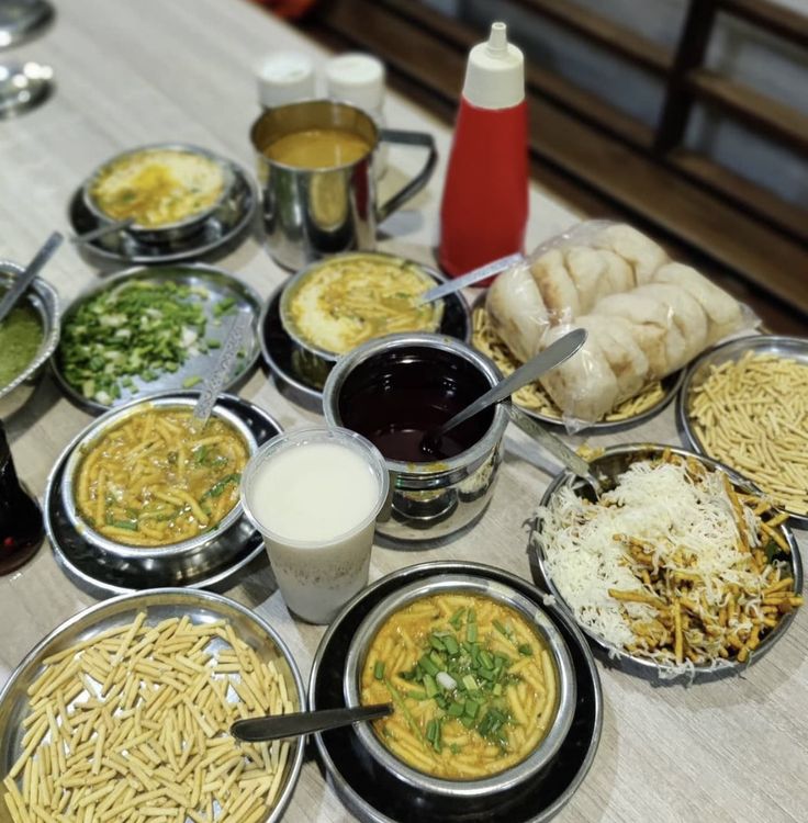 a table topped with lots of different types of food and condiments on top of it