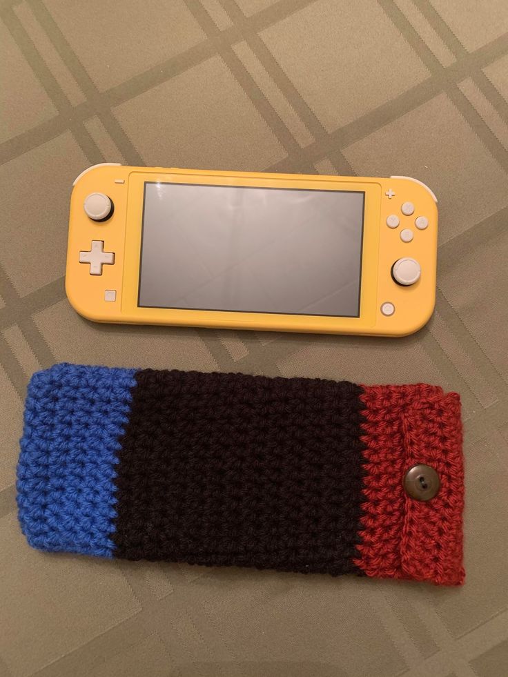 two knitted nintendo wii controllers sitting next to each other