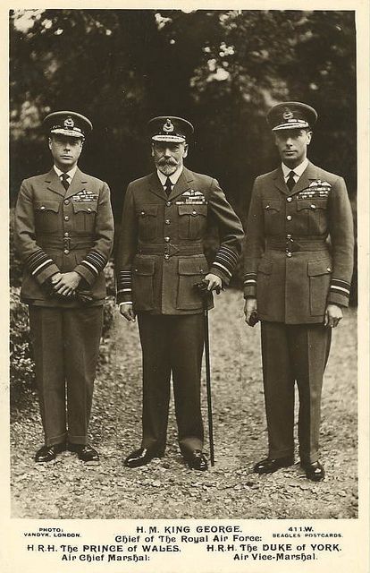 three men in uniforms standing next to each other