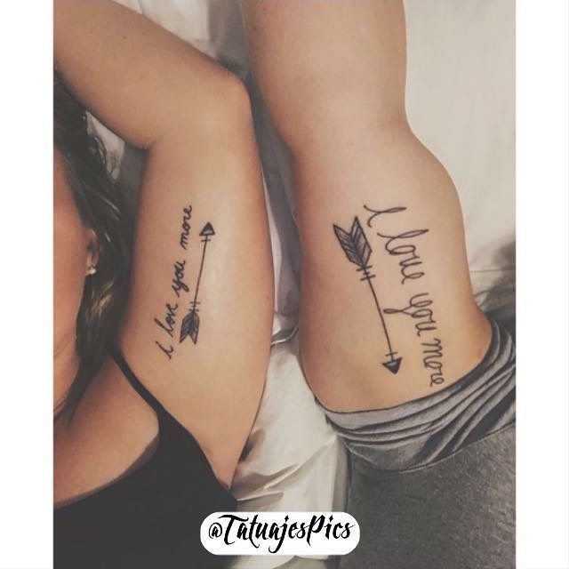 two women with matching tattoos on their arms, one has an arrow and the other says love