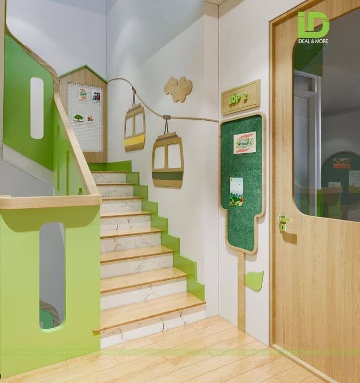 the interior of a children's playroom with wooden stairs and green walls,