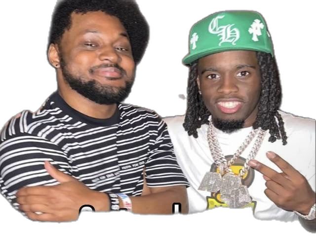 two young men with dreadlocks and hats posing for the camera, one wearing a green hat