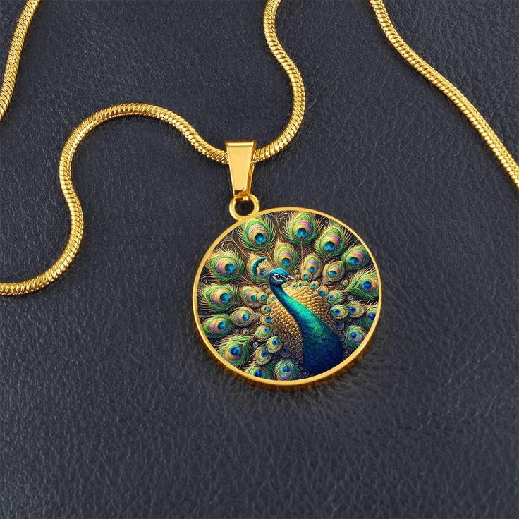 Admire the elegance of the Radiant Peacock Pendant Necklace, featuring a breathtaking stained glass style illustration of a peacock in full feather display. This intricate design showcases the peacock's vibrant plumage with stunning detail, capturing the essence of its regal beauty. Forged from premium surgical steel and available with a lavish 18k gold finish, this innovative jewelry boasts our exclusive design, handcrafted with care right here in the U.S.A by our dedicated team of skilled work Spiritual Jewelry With Peacock Design As A Gift, Spiritual Peacock Design Jewelry As Gift, Peacock Design Jewelry Gift, Peacock Design Jewelry For Gifts, Peacock Design Jewelry As Gift, Peacock Design Pendant Necklace Gift, Peacock Design Pendant Necklace As Gift, Round Peacock Design Jewelry Gift, Feather Display