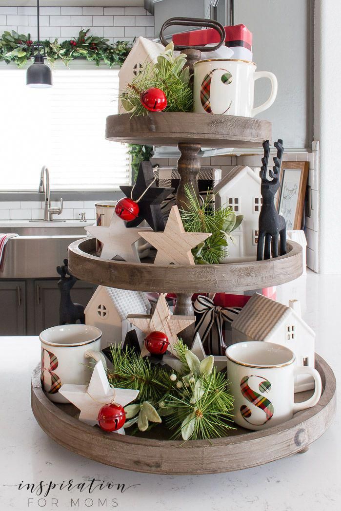 a christmas tree made out of three tiered trays filled with coffee mugs