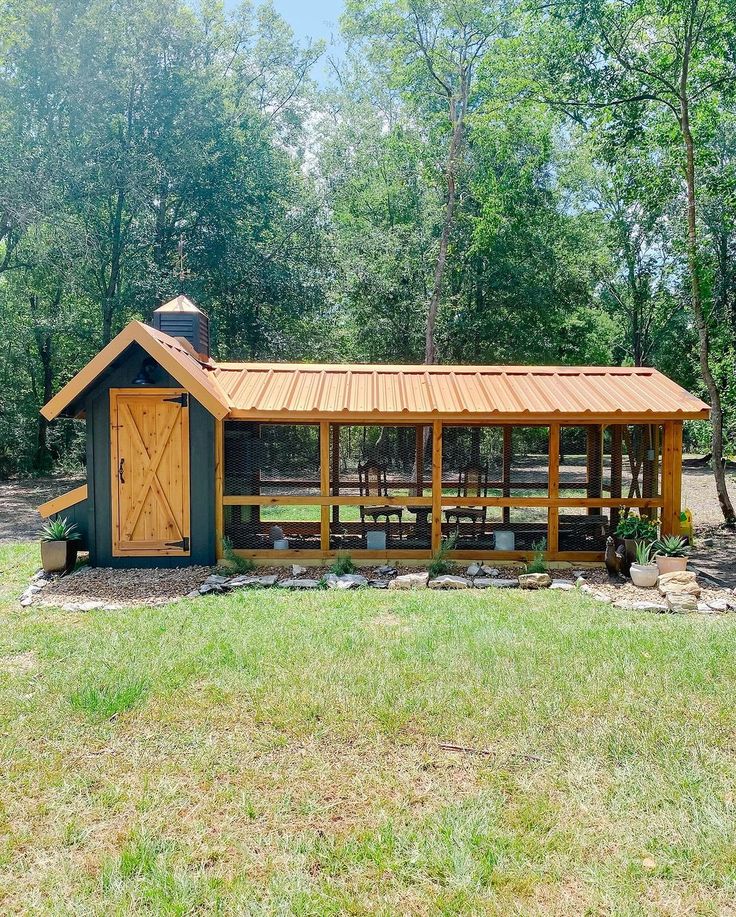 a small shed with a picnic table in the yard