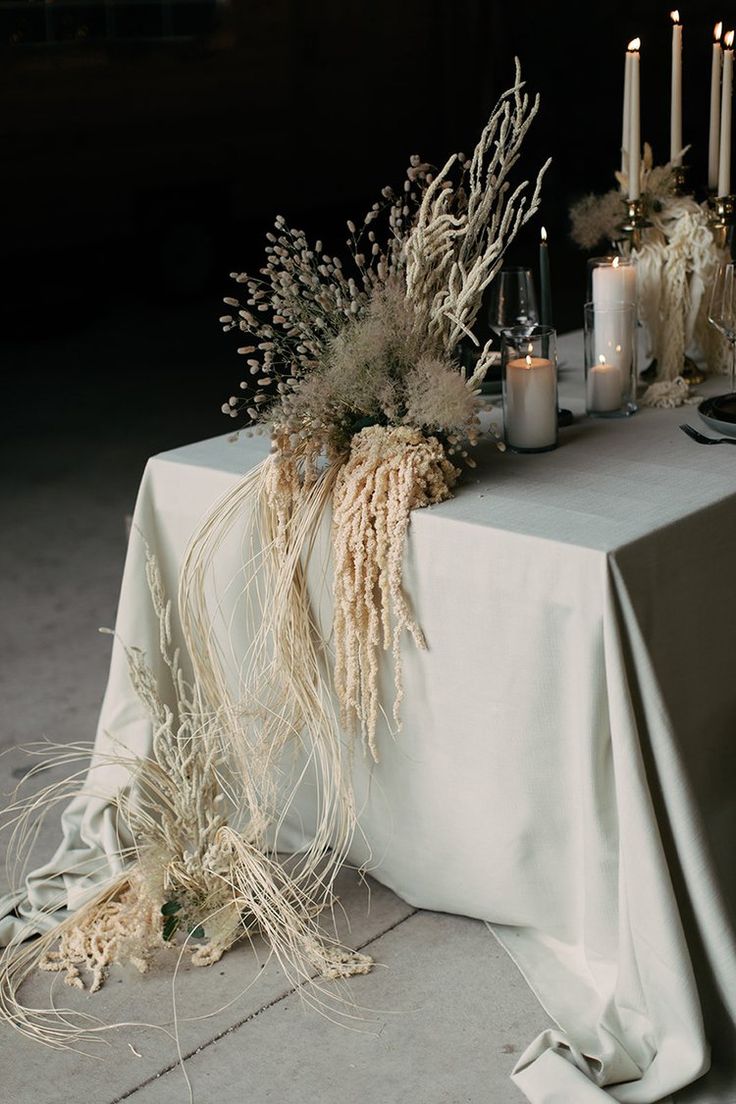 the table is set with candles, flowers and other things to be used for decoration