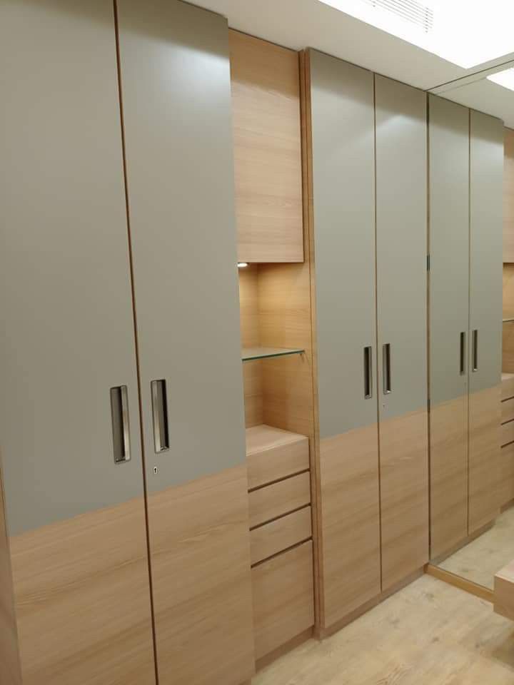 the closets are made of wood and have glass doors on each side, along with drawers