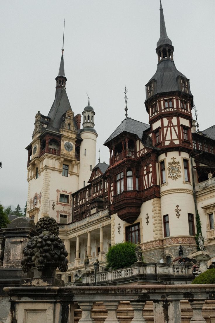 an old building with two towers and a clock on the front