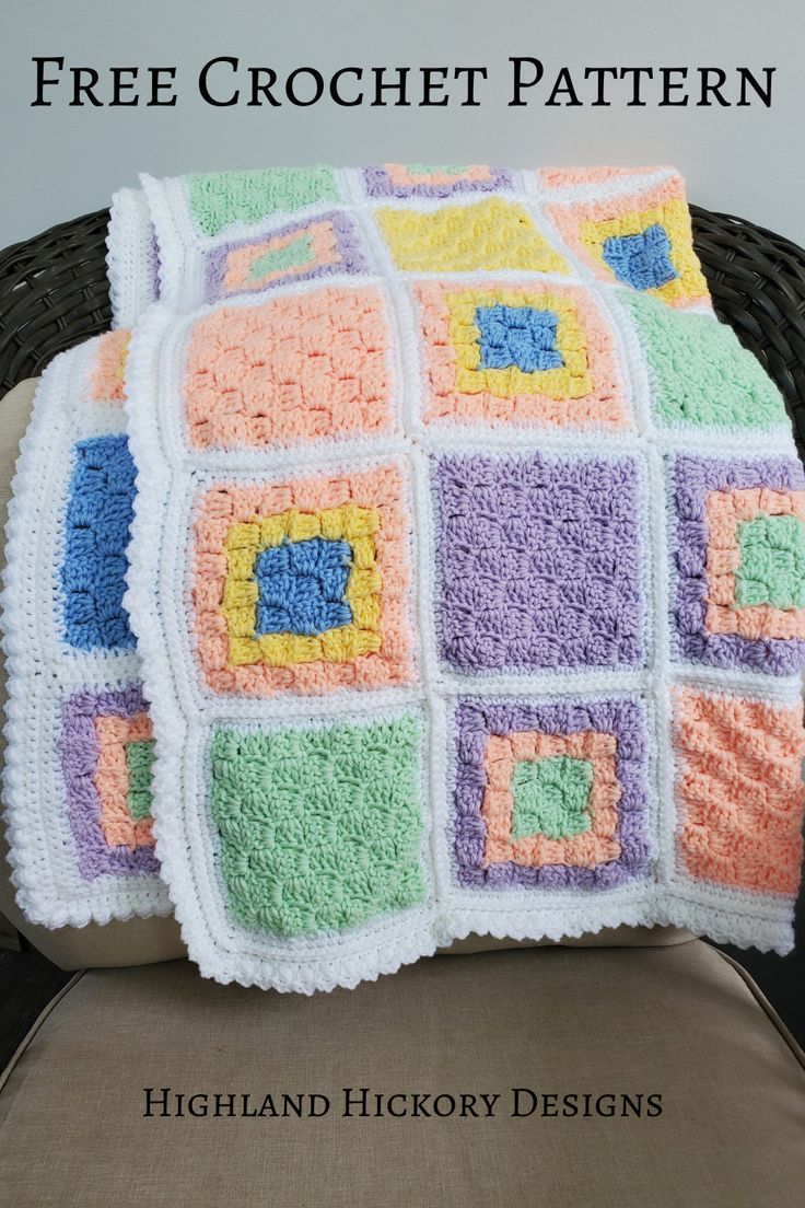 a crocheted granny blanket sitting on top of a chair next to a pillow